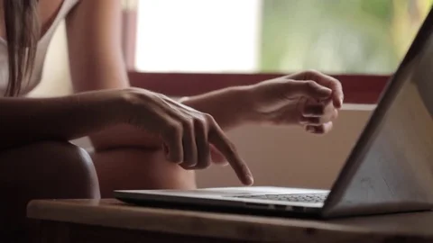 Young woman using laptop computer at home Stock Footage 74595077