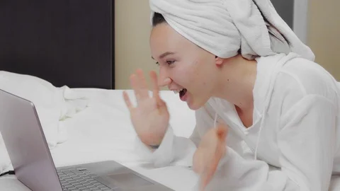 Young woman using a laptop computer to make a video call. Video stock 125171898