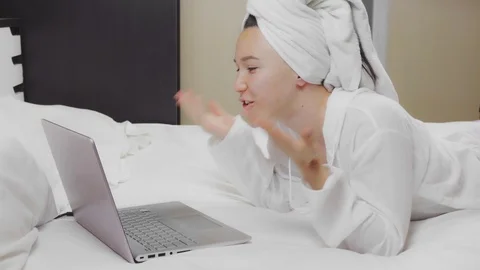 Young woman using a laptop computer to make a video call. Video stock 125366326