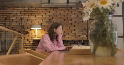 Young woman using laptop computer surfing social media, checking news, playing Stock Footage 156780766