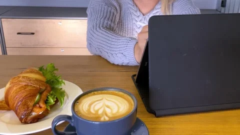 Young woman using laptop computer drinking coffee. Stock Footage 252116645