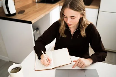 Young woman using laptop computer for studying having online virtual webina.. Foto stock