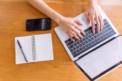 Young woman using laptop on her desk Stock Photos
