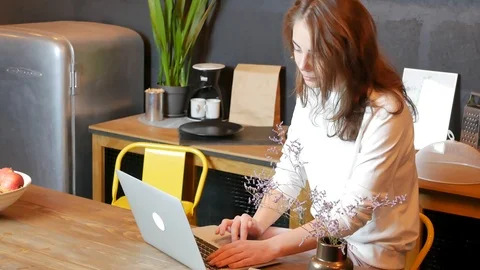 Young woman using laptop at kitchen Video stock 117992985