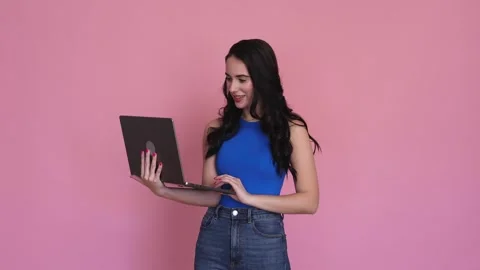 Young woman using laptop in studio shot. Stock Footage 240386716