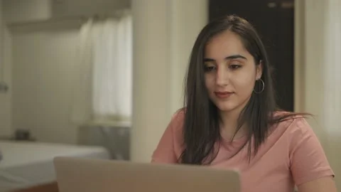 A young woman is using laptop to work on office project Video stock 147340966