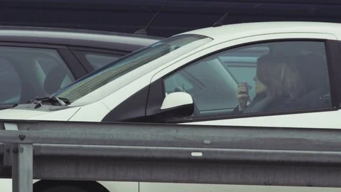 Young Woman Using a Lipstick When Sitting in her Car Stock Footage 79312958