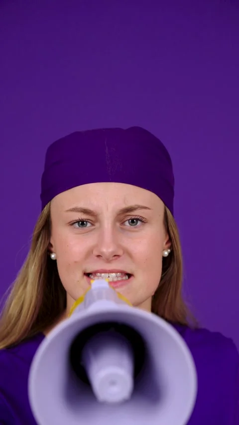 Young woman using megaphone looking at camera Stock Footage 253164635