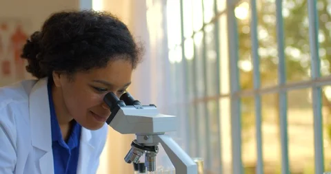 Young woman using a microscope. Stock-Footage 88372086