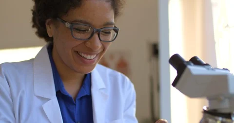Young woman using a microscope. Stock Footage 88372332