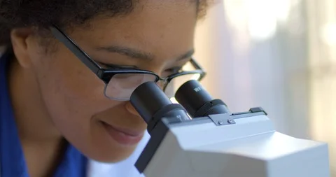 Young woman using a microscope. 库存影片 88372396