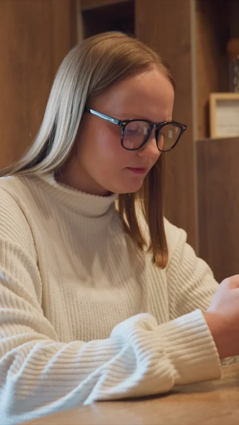 Young Woman Using Mobile Device in Cafe Break Time featuring student phone Stock Footage 348174761