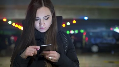Young Woman using Mobile on parking Stock Footage 86980145