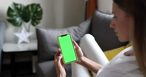 Young woman using mobile phone with green screen for copy space closeup. Chroma Stock Footage 163829185
