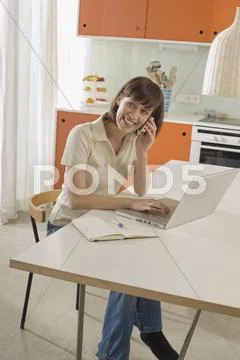 Young woman using mobile phone, smiling, portrait Stock Photos