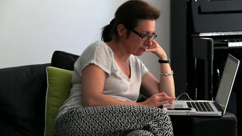 Young Woman Using Notebook And Smartphone at Home Stock Footage 72433425