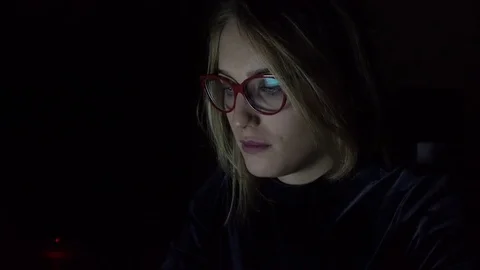 Young woman using notebook at night, close-up Stock Footage 83635279
