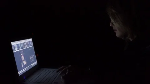 Young woman using notebook at night, close-up Stock Footage 83635442