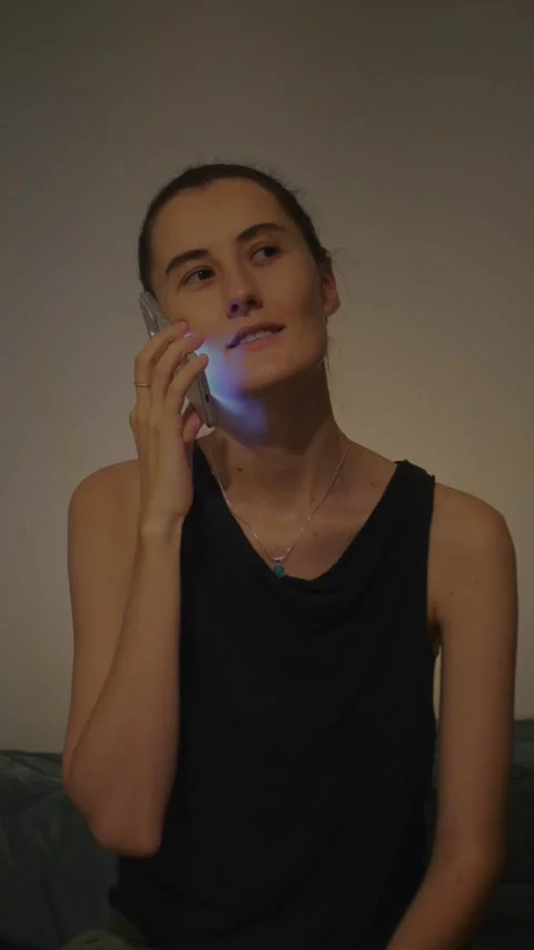 Young woman using or talking osmartphone in a warm bedroom... Video stock 337972466