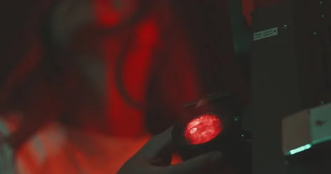 Young woman using a projector manually Stock Footage 203593386