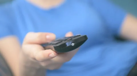 Young woman using remote control in living room Stock Footage 62909428