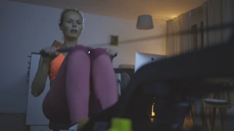 Young woman using a rowing machine. Stock Footage 127312970