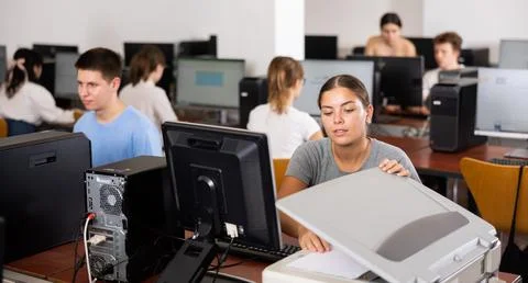 Young woman using scanner in computer class Foto stock