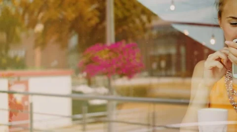 Young Woman using Smartphone in a Cafe, drinking coffee. Slow Motion. Stock Footage 67223562