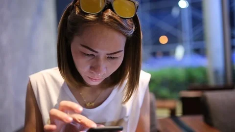 Young woman using smartphone checking sms in phone Stock Footage 93444766