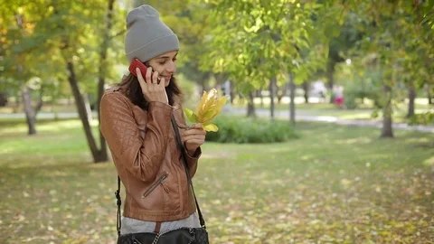 Young woman using smartphone during walk in city park Video stock 72706750