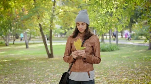 Young woman using smartphone during walk in city park Video stock 72707399
