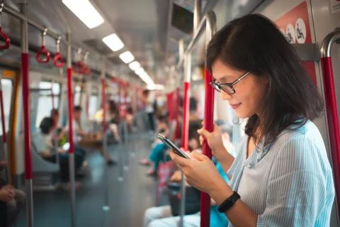 Young woman using smartphone inside the Train Stock Photos