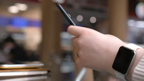 Young woman using smartphone at mall. Caucasian girl looking at mobile phone in Stock Footage 238526233