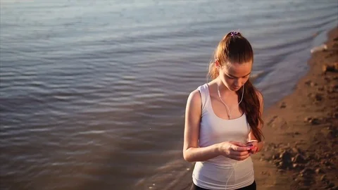 Young woman using smartphone outside. Stock Footage