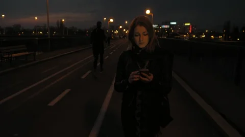 Young woman using smartphone outside Stock Footage 87939335