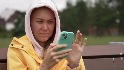 Young woman using smartphone on park bench Stock Footage 344876989