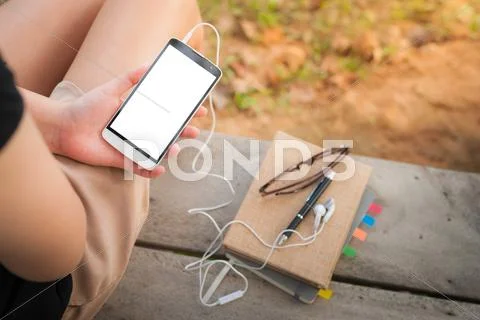 Young woman using smartphone in park Stock Photos