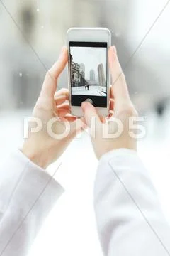 Young Woman Using Smartphone To Photograph The Christian Science Centre And