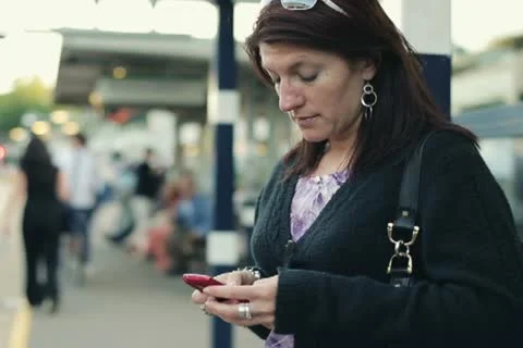 Young woman using smartphone on train station NTSC Stock Footage 11469697