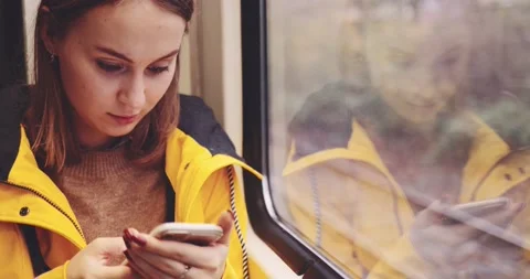 Young Woman Using Smartphone on a Train. SLOW MOTION 4K. Stock Footage 140295690
