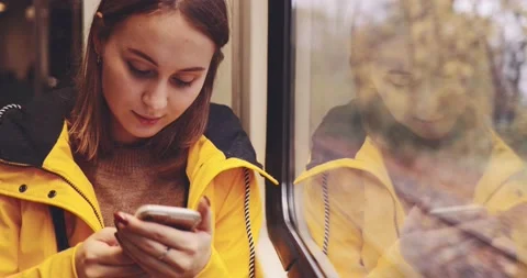 Young Woman Using Smartphone on a Train. SLOW MOTION 4K. Stock Footage 140322089
