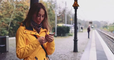 Young Woman Using Smartphone at the Train Station. SLOW MOTION 4K. Stock Footage 140367531