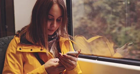 Young Woman Using Smartphone on a Train. SLOW MOTION 4K. Stock Footage 140367559