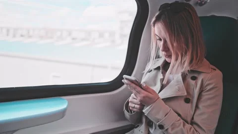 Young Woman Using Smartphone on a Train, technology, daily commute. SLOW MOTION 스톡 동영상 140368577