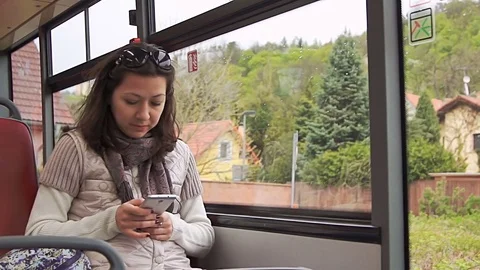 Young woman using smartphone while riding bus Stock Footage 75442076