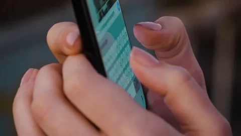 Young woman using smartphone while doing homework. Young people and college educ Stock Footage 120120731