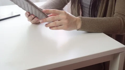 Young woman using smartphone while doing homework. Video stock 122918900