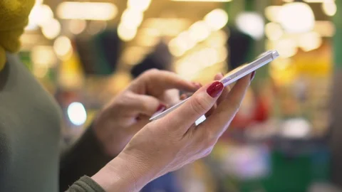 Young woman using smartphone while doing homework. Young people and college Stock Footage 124880602