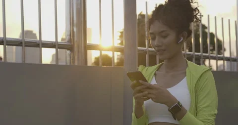 Young woman using smartphone while exercise at city. Stock Footage 147054111