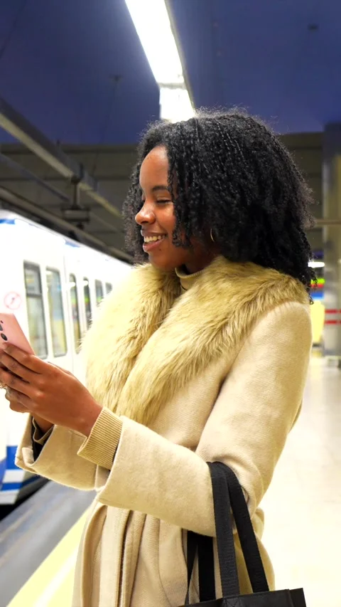 Young woman using smartphone while waiting for subway Stock Footage 297177510